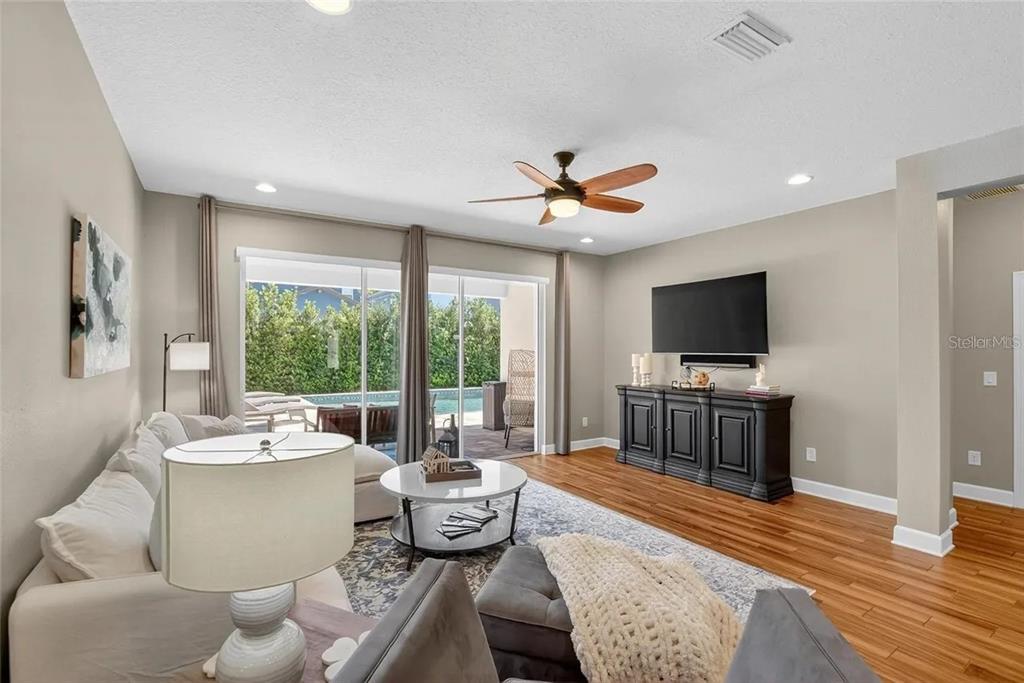 14302 Rolling Dune Road Lithia, FL 33547 - Photo 16 of 88 a living room with furniture and a flat screen tv