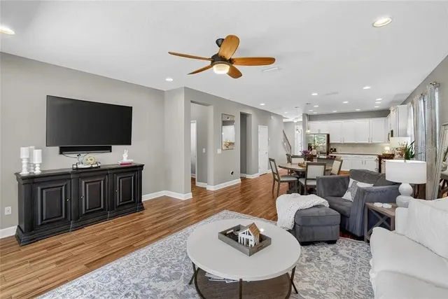 a bedroom with a bed chandelier and a window