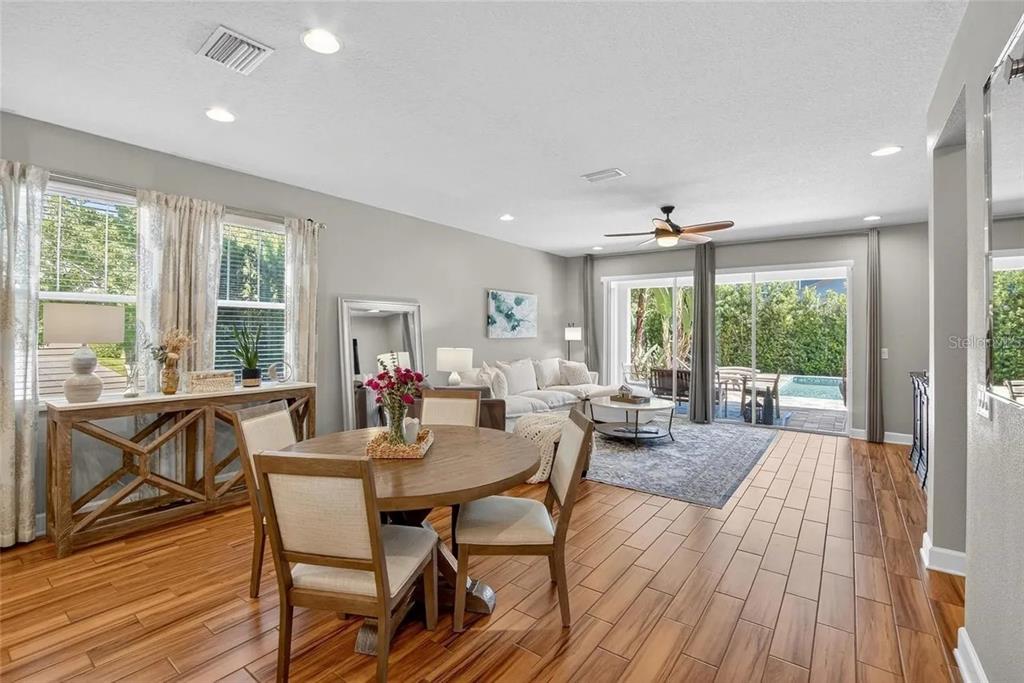 14302 Rolling Dune Road Lithia, FL 33547 - Photo 18 of 88 a view of a dining room with furniture large windows and wooden floor