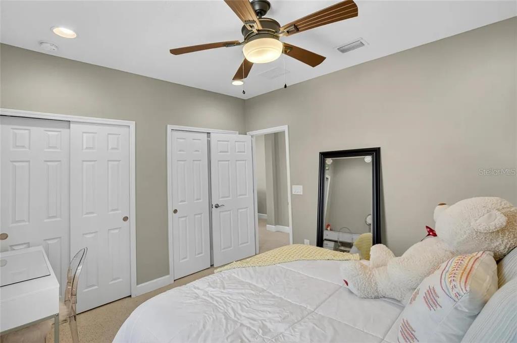 14302 Rolling Dune Road Lithia, FL 33547 - Photo 22 of 88 a bedroom with a bed and a chandelier