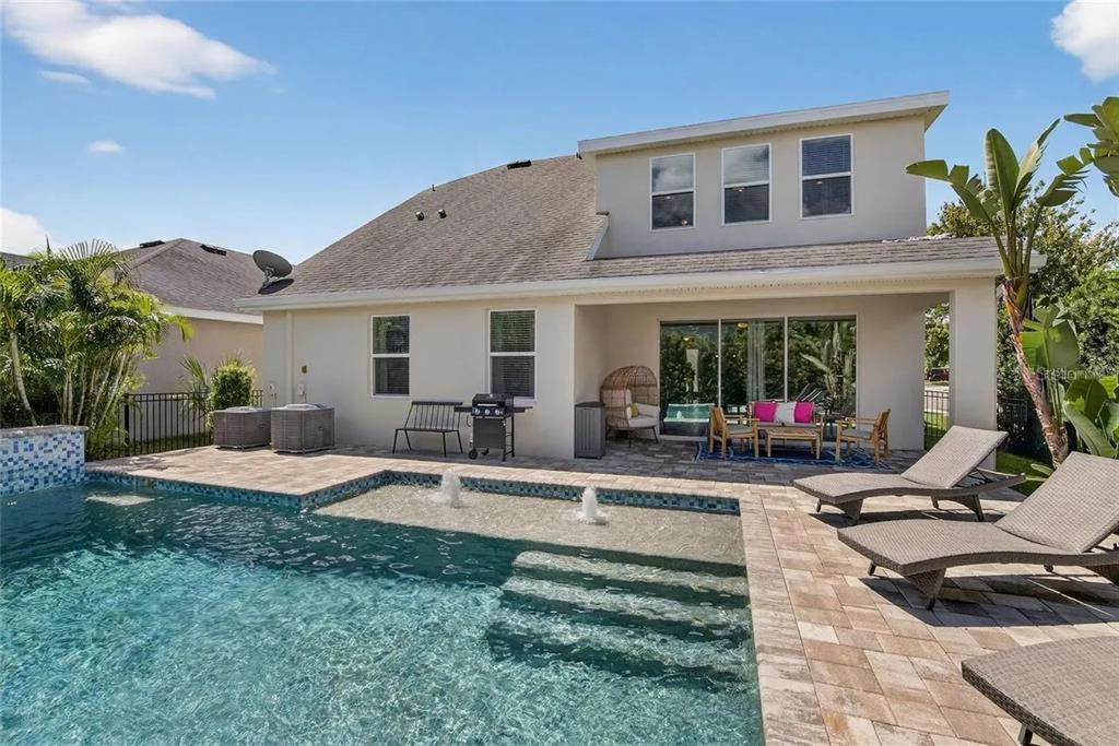 14302 Rolling Dune Road Lithia, FL 33547 - Photo 28 of 88 a view of a house with backyard sitting area and garden