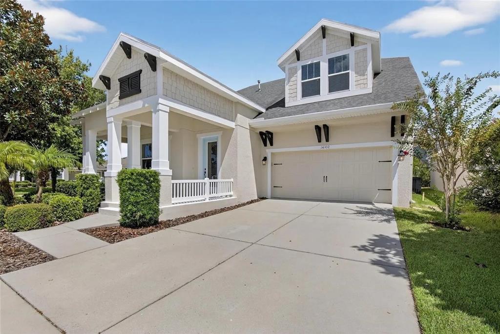 14302 Rolling Dune Road Lithia, FL 33547 - Photo 3 of 88 a front view of a house with a yard garage and outdoor seating