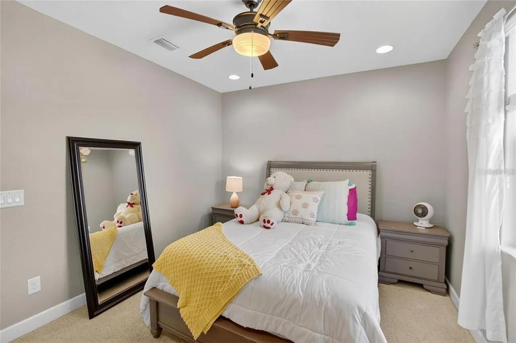 14302 Rolling Dune Road Lithia, FL 33547 - Photo 36 of 88 a bedroom with a bed and a chandelier