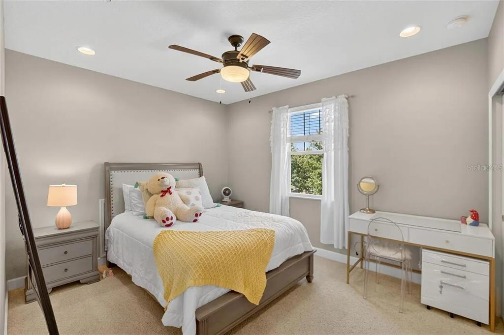 14302 Rolling Dune Road Lithia, FL 33547 - Photo 37 of 88 a bedroom with a bed and a chandelier