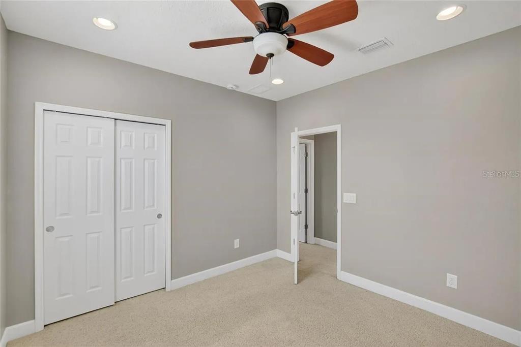 14302 Rolling Dune Road Lithia, FL 33547 - Photo 40 of 88 an empty room with closet and a ceiling fan