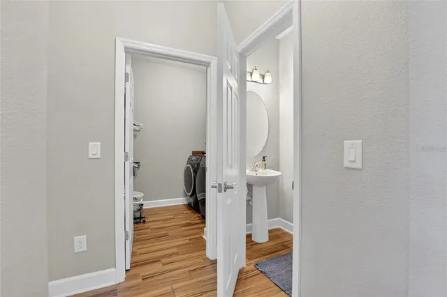 a front view of a house with a yard and potted plants
