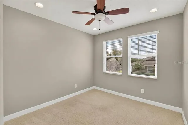 an aerial view of a house with a yard basket ball court and outdoor seating