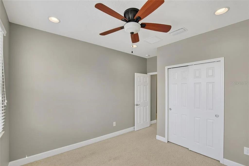 14302 Rolling Dune Road Lithia, FL 33547 - Photo 53 of 88 an empty room with a ceiling fan and a ceiling fan
