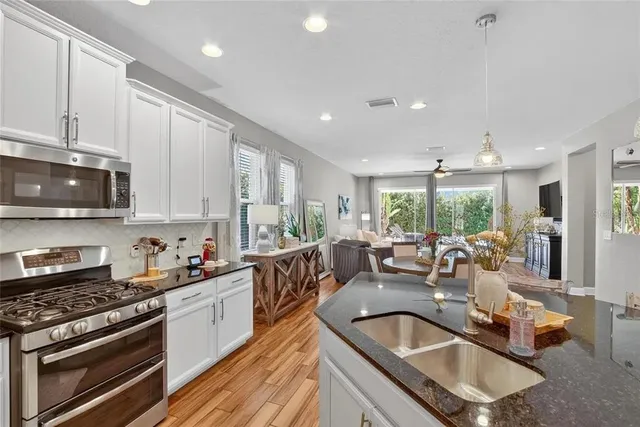 a view of a dining room with furniture large windows and wooden floor