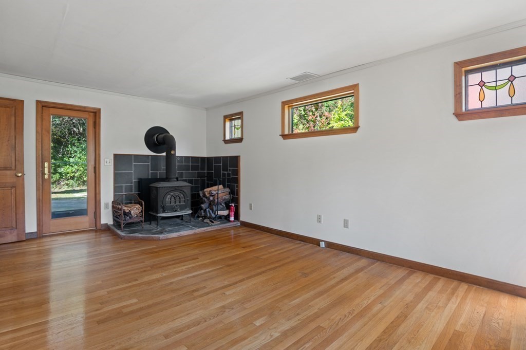 54 Harriman Road Merrimac, MA 01860 - Photo 13 of 39 a view of a livingroom with a fireplace and a window