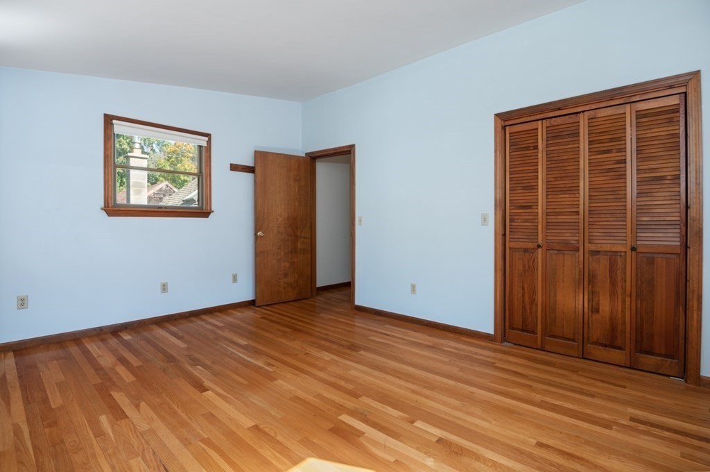 54 Harriman Road Merrimac, MA 01860 - Photo 18 of 39 a view of an empty room with wooden floor and a window