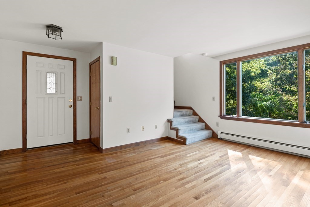 54 Harriman Road Merrimac, MA 01860 - Photo 4 of 39 a view of an empty room with wooden floor and a window