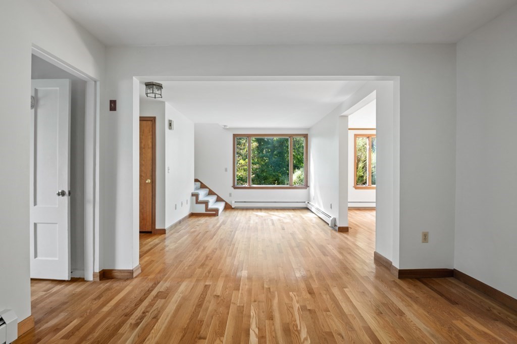 54 Harriman Road Merrimac, MA 01860 - Photo 5 of 39 a view of an empty room with wooden floor and a window