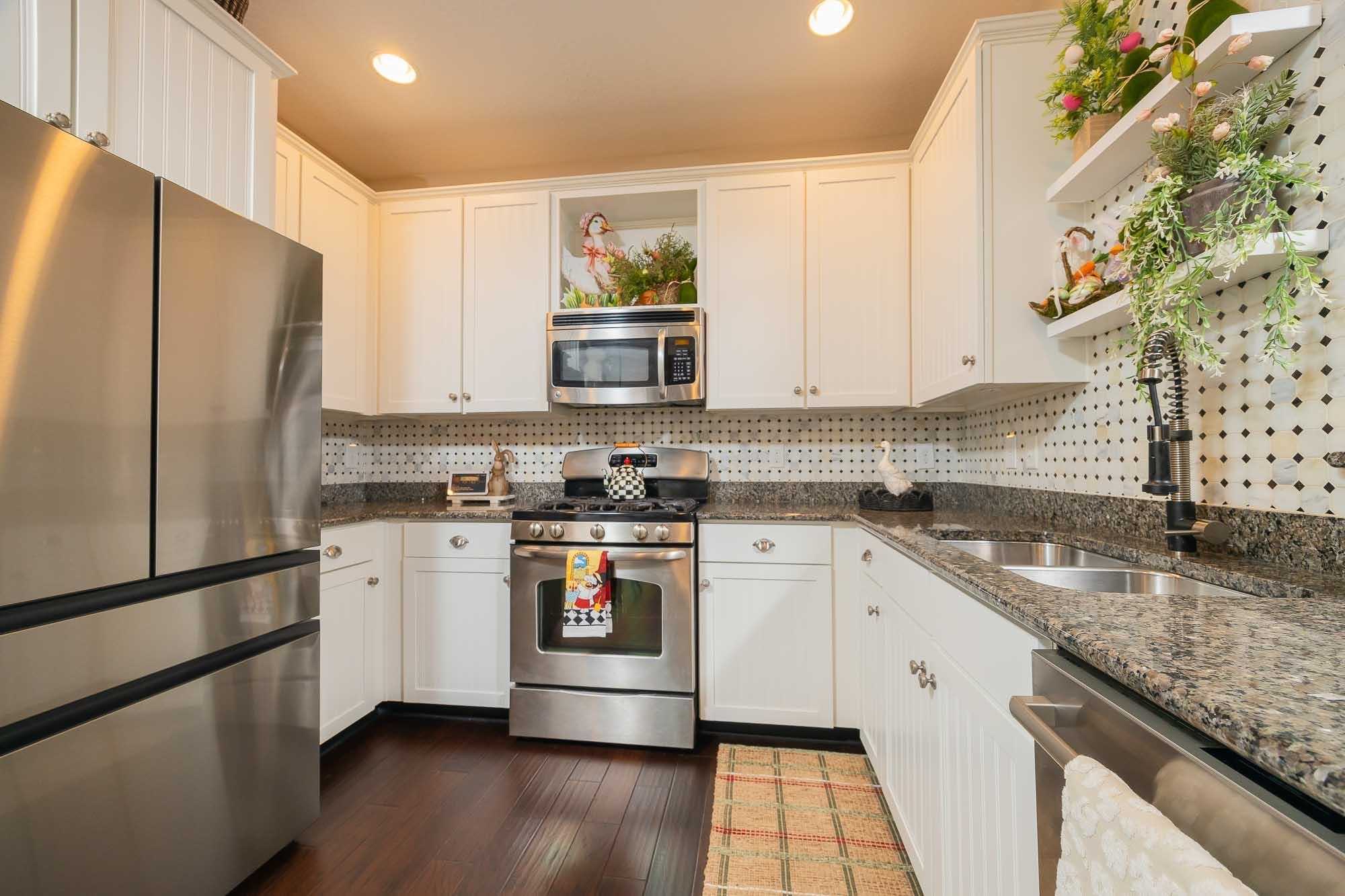 64 Grand Ravine Drive St. Augustine, FL 32086 - Photo 19 of 57 a kitchen with stainless steel appliances granite countertop a refrigerator sink and stove