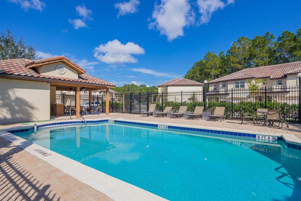 64 Grand Ravine Drive St. Augustine, FL 32086 - Photo 56 of 57 a view of a house with swimming pool and a yard