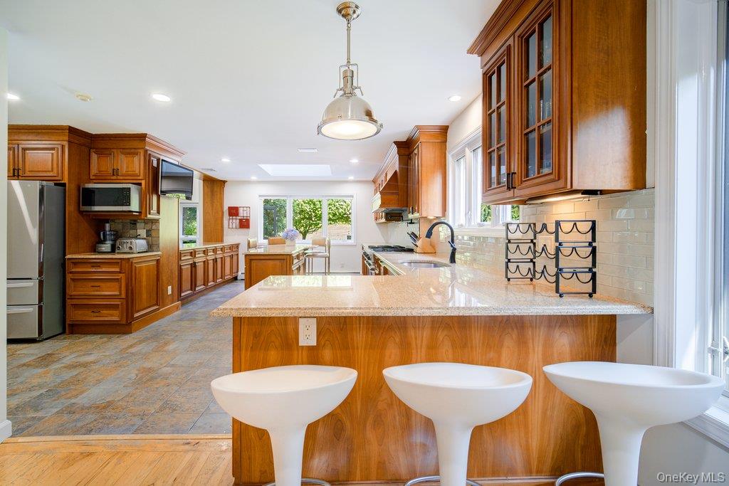 237 Mineral Springs Road Highland Mills, NY 10930 - Photo 13 of 32 Kitchen with brown cabinetry, tasteful backsplash, light stone counters, and recessed lighting