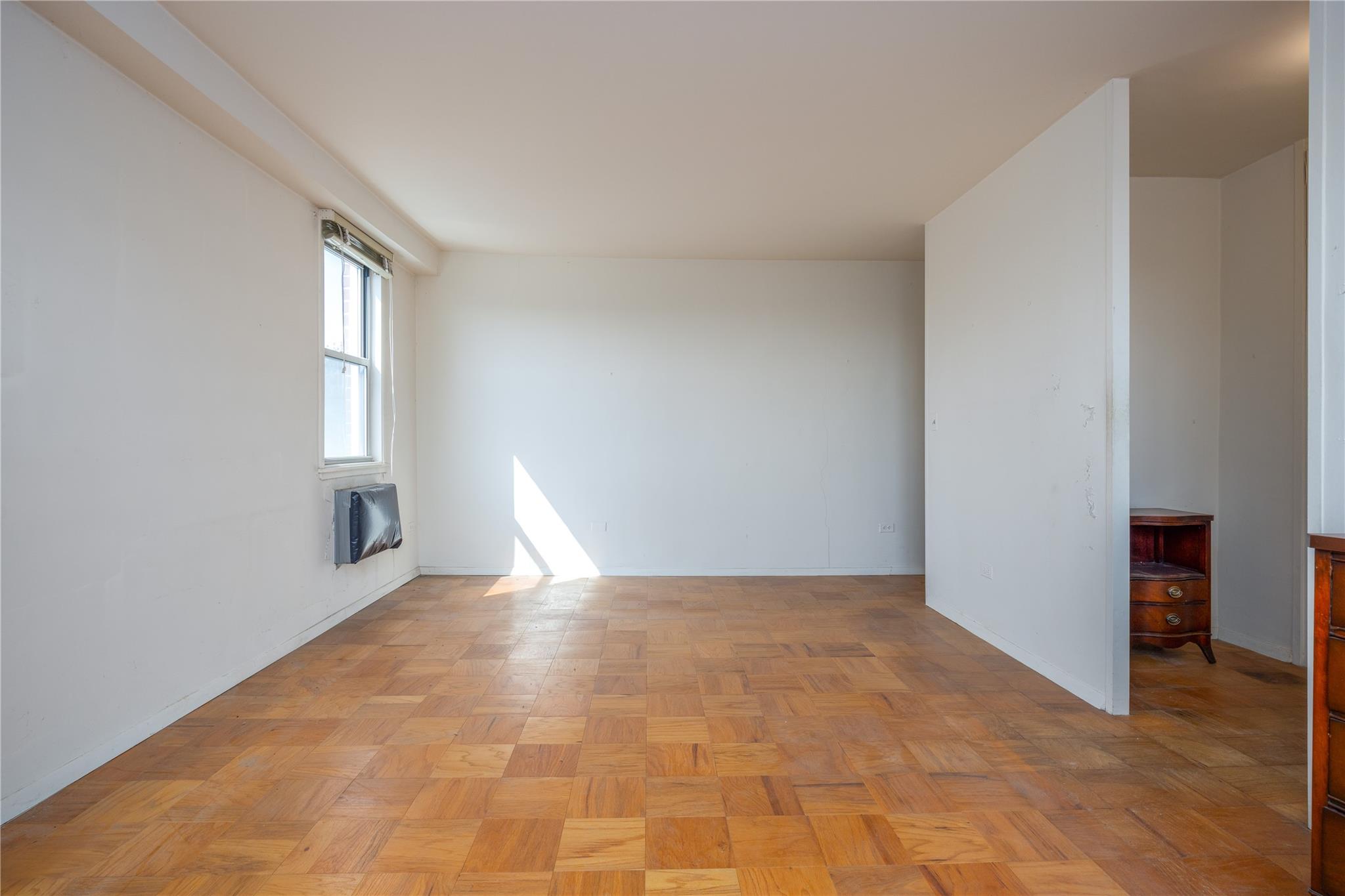 615 Palmer Road, Unit 602 Yonkers, NY 10701 - Photo 14 of 23 a view of an empty room with window and wooden floor