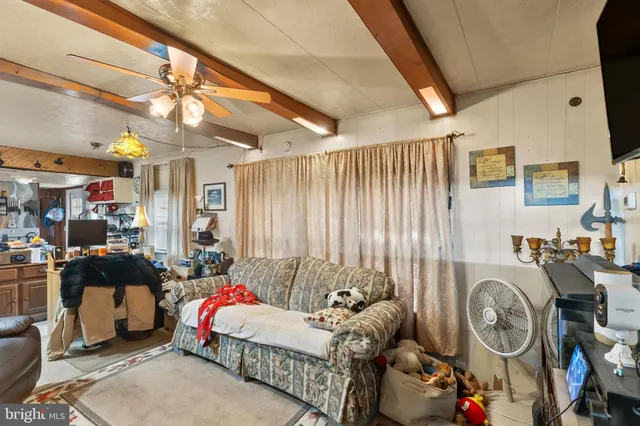 a bedroom with furniture and a fan