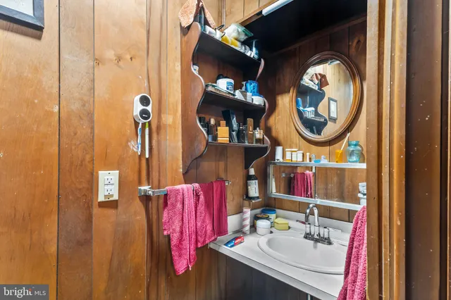 a bathroom with a sink vanity and a mirror