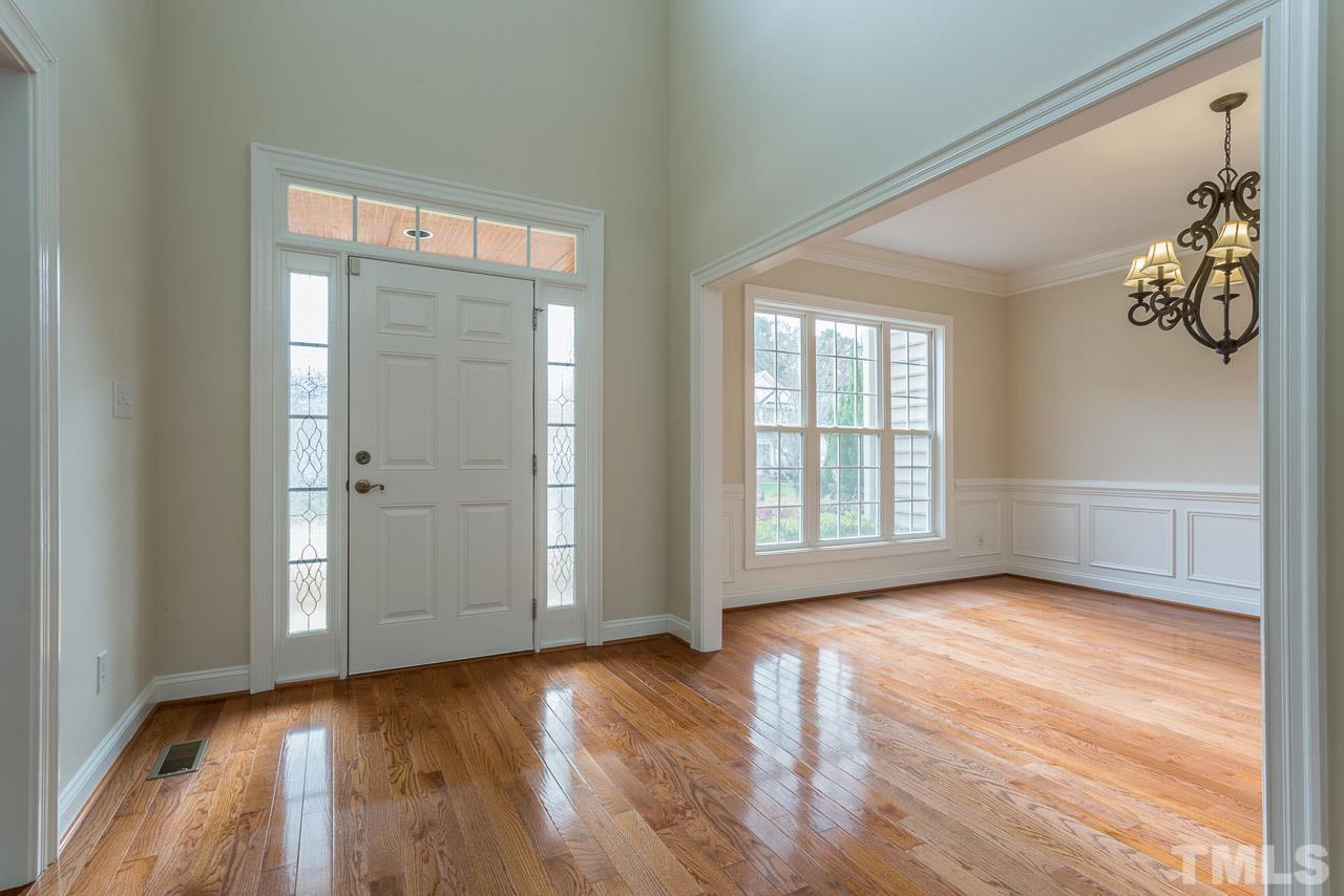 4208 Russling Leaf Lane Raleigh, NC 27613 - Photo 5 of 25 an empty room with wooden floor and windows
