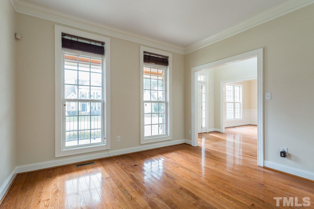 4208 Russling Leaf Lane Raleigh, NC 27613 - Photo 6 of 25 a view of empty room with wooden floor and fan
