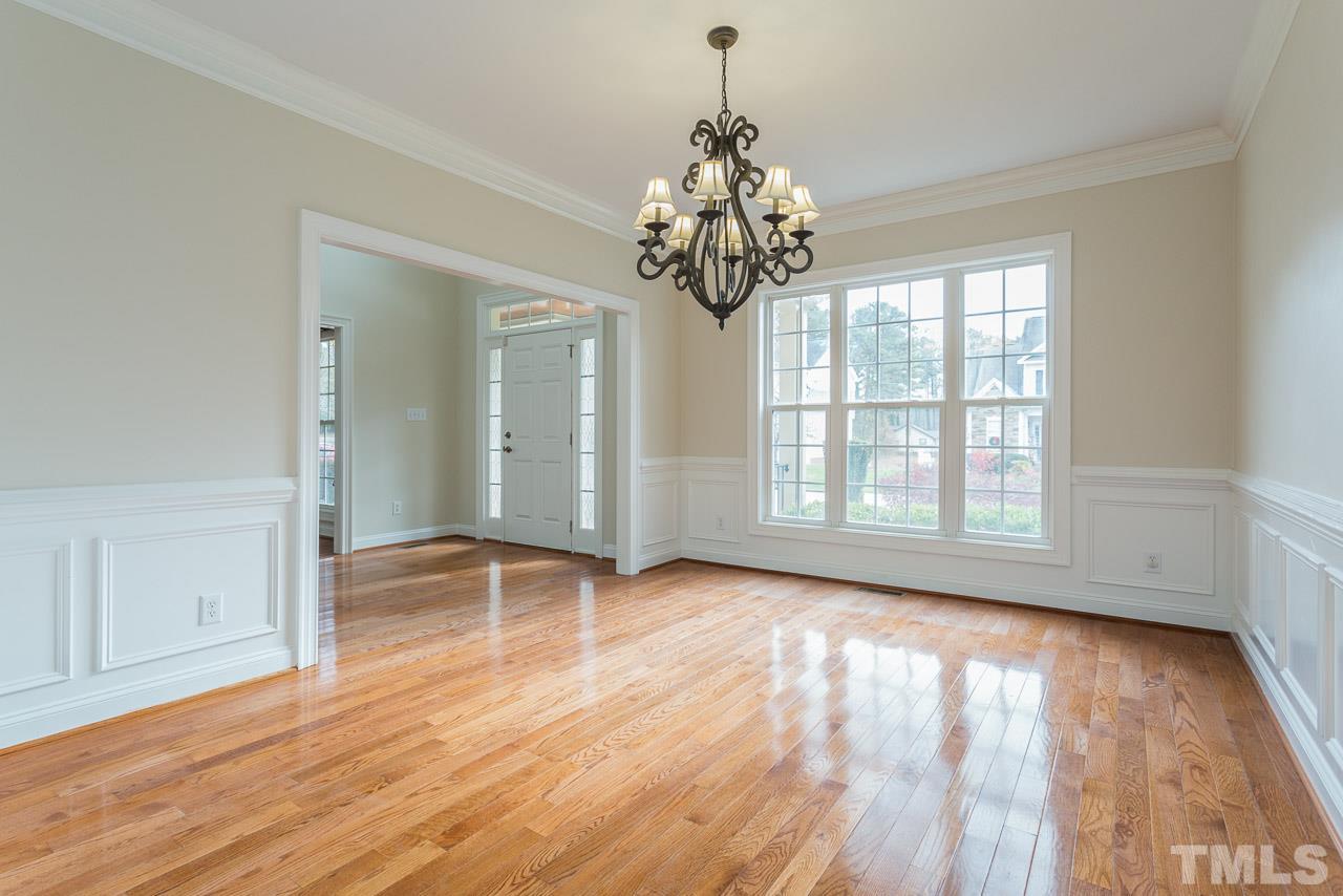 4208 Russling Leaf Lane Raleigh, NC 27613 - Photo 7 of 25 a view of an empty room with wooden floor and a window