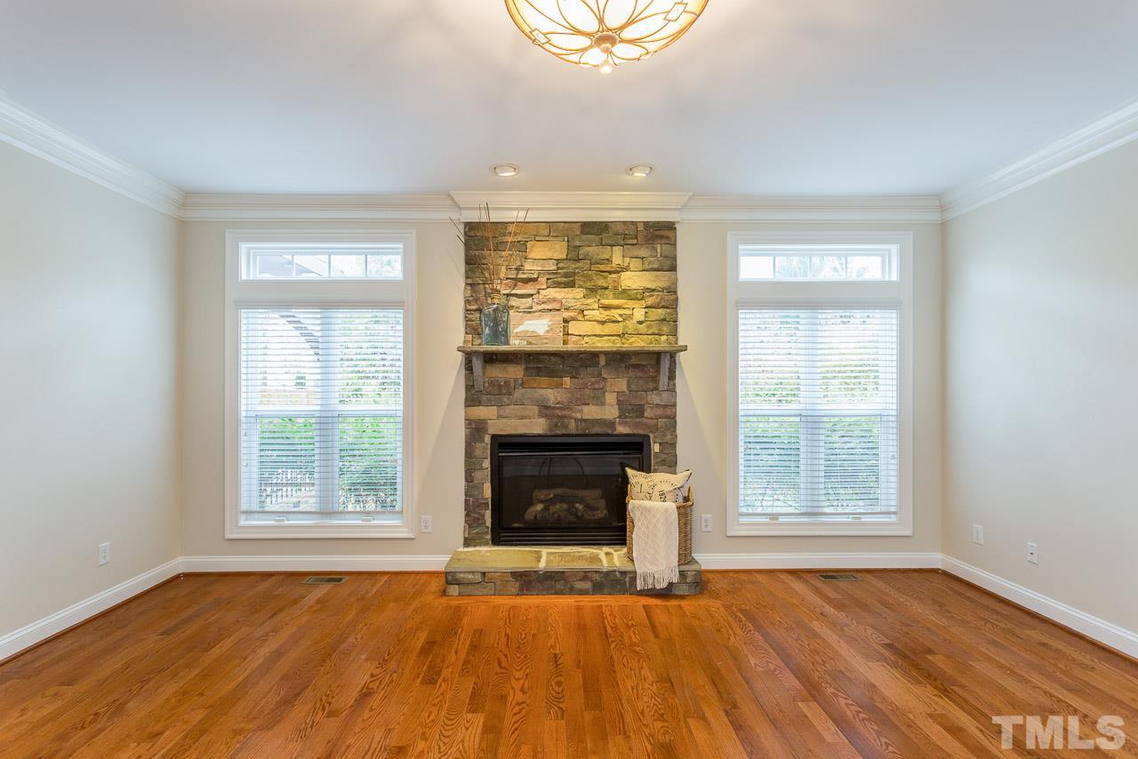 4208 Russling Leaf Lane Raleigh, NC 27613 - Photo 9 of 25 an empty room with windows and fireplace
