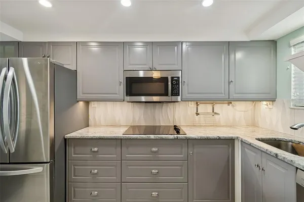 a kitchen with a refrigerator and a sink