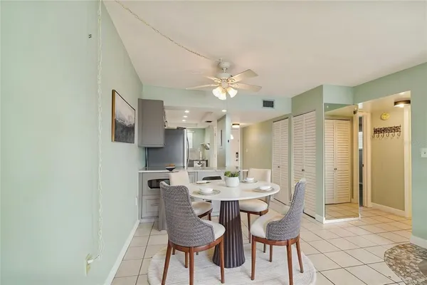 a view of a dining room with furniture and a chandelier fan