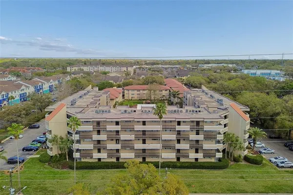 an aerial view of a large building with a yard