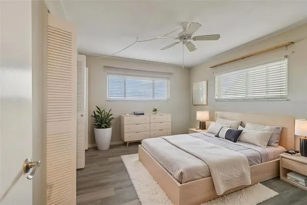 a bedroom with a large bed and a window