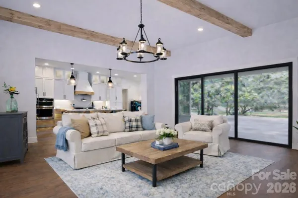 a living room with furniture potted plant and a large window