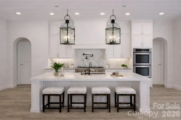 a kitchen with granite countertop kitchen island cabinets and stainless steel appliances