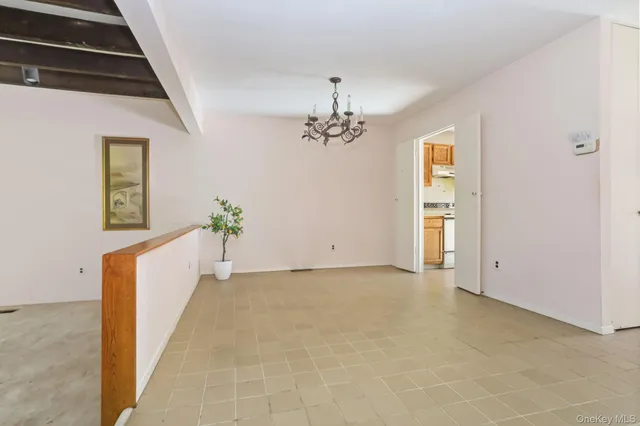 a view of an empty room with a fireplace and a window