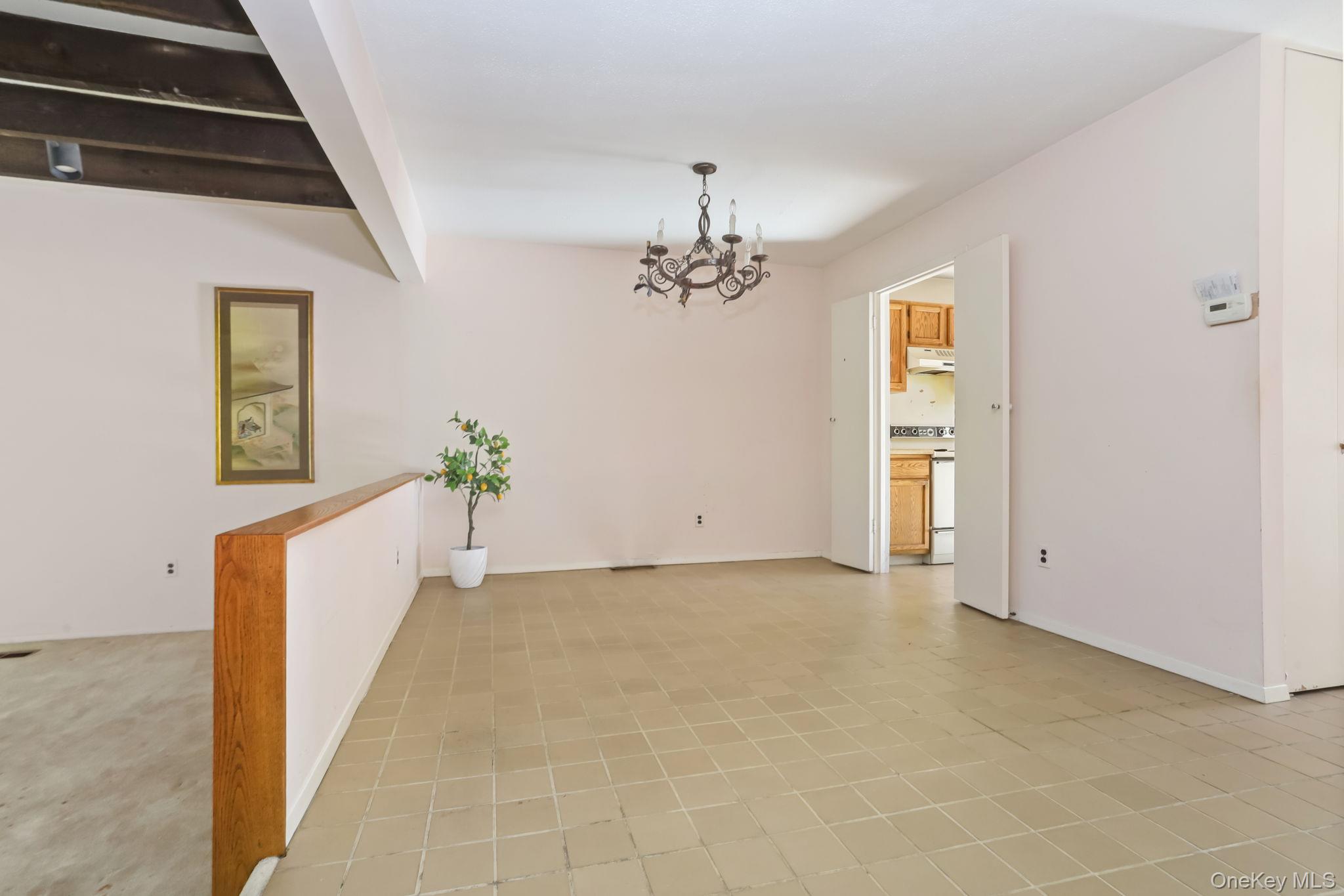 40 Pine Ridge Road Larchmont, NY 10538 - Photo 11 of 40 a view of a hallway with wooden floor and a chandelier