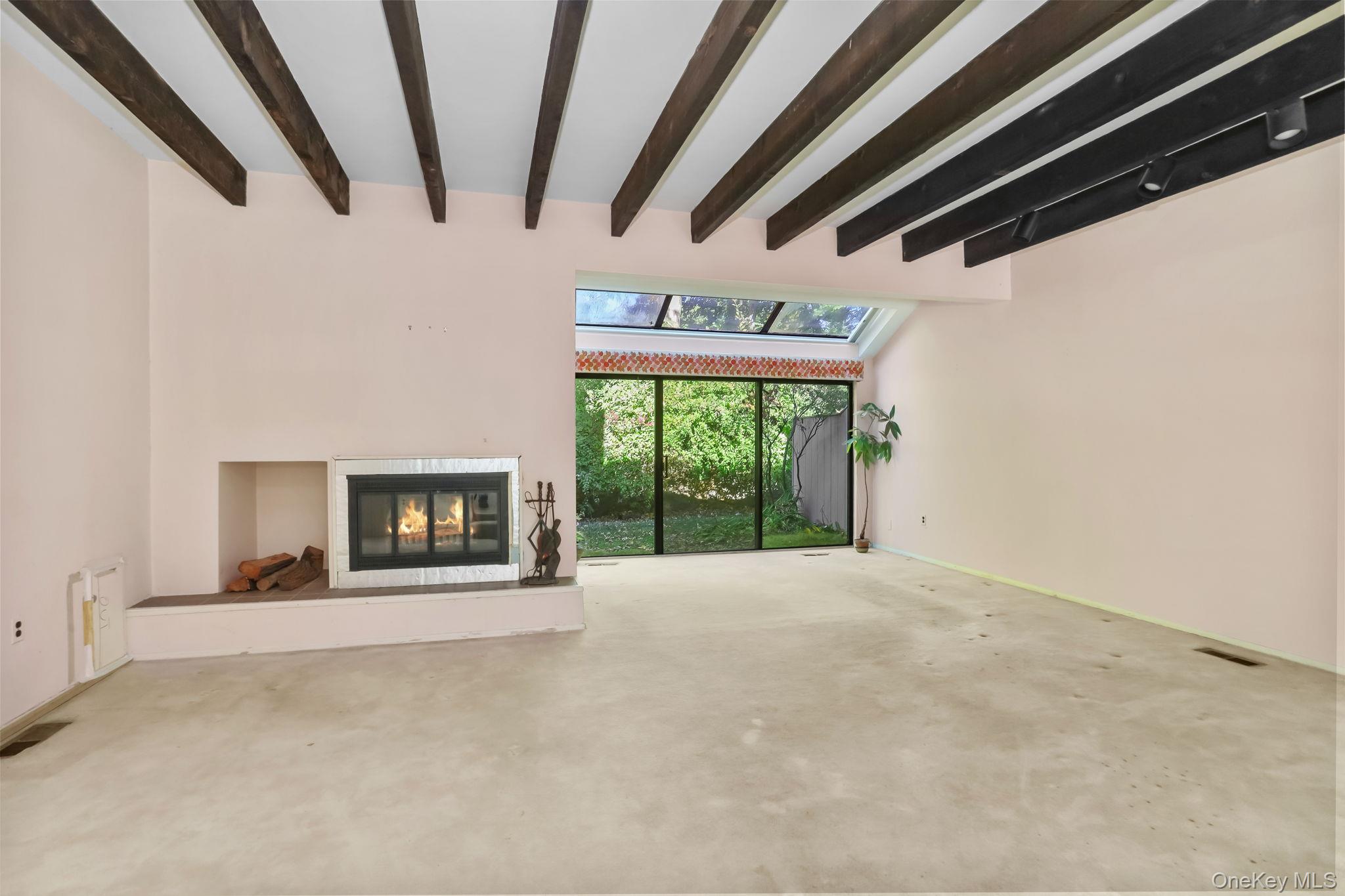 40 Pine Ridge Road Larchmont, NY 10538 - Photo 13 of 40 a view of an empty room with a fireplace and a window