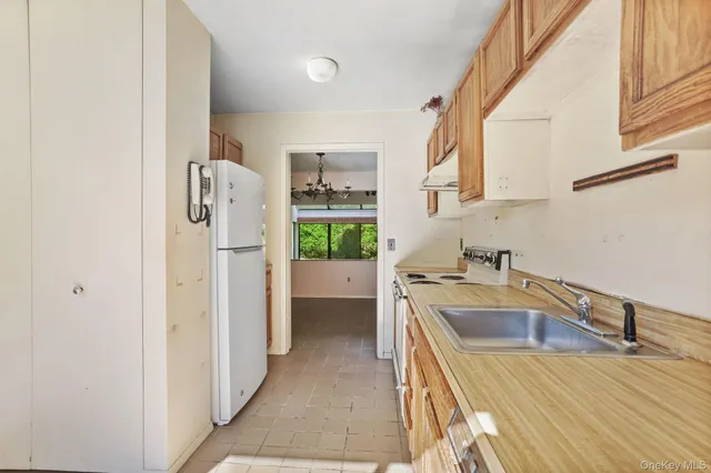 a dining room with furniture and a floor to ceiling window