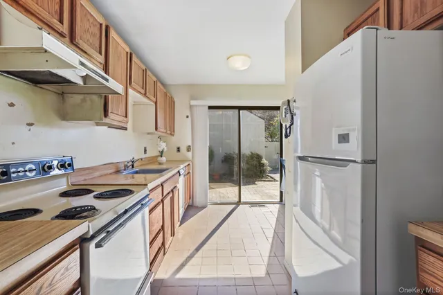 a view of a kitchen area with furniture and wooden floor