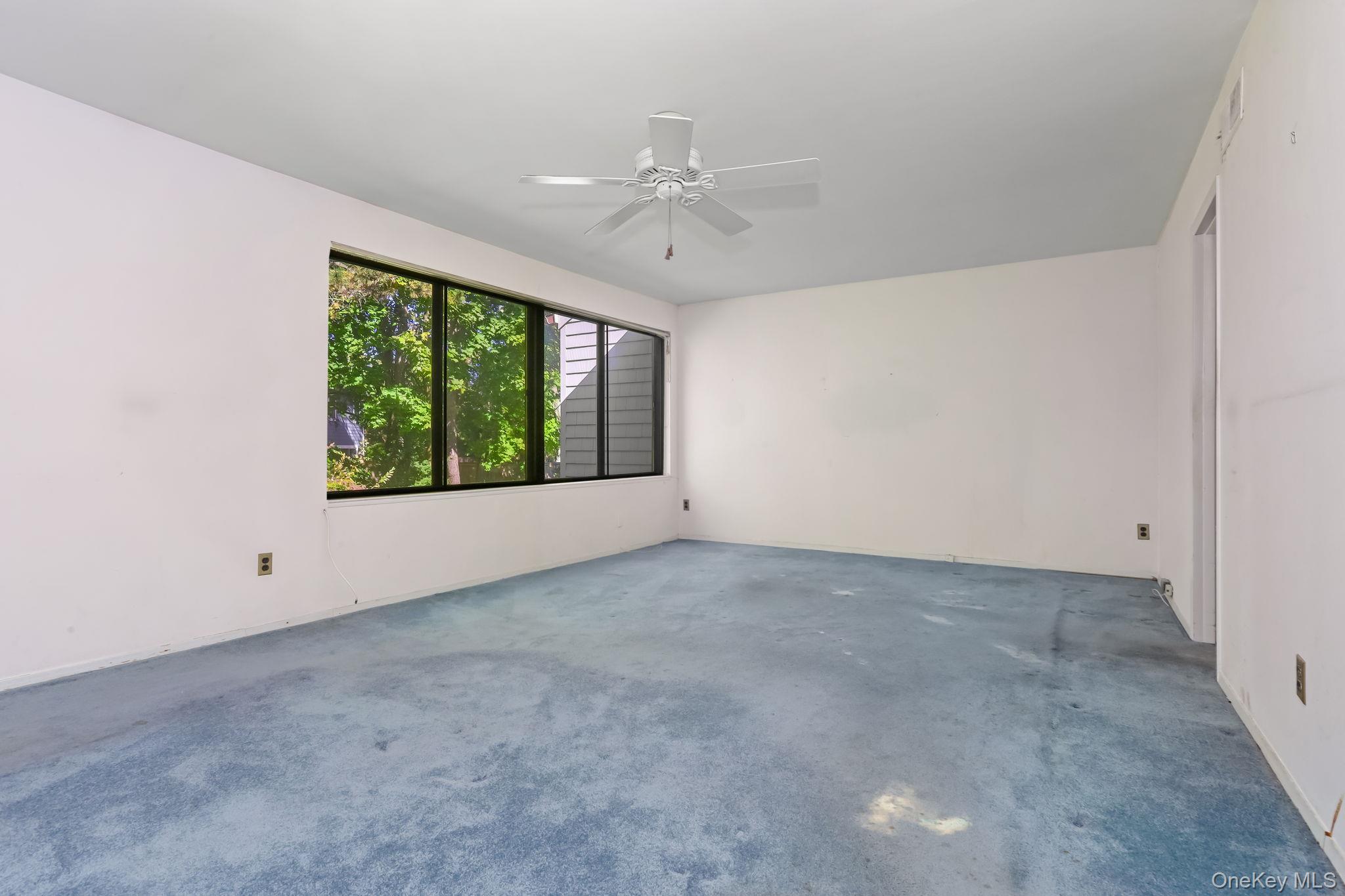 40 Pine Ridge Road Larchmont, NY 10538 - Photo 24 of 40 an empty room with a window and a ceiling fan