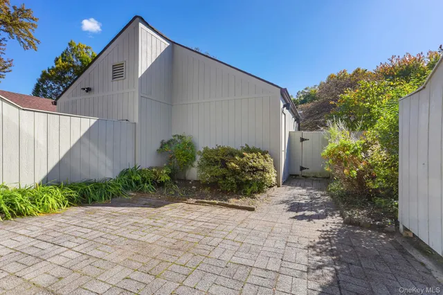 a view of a room with a chandelier and wooden floor