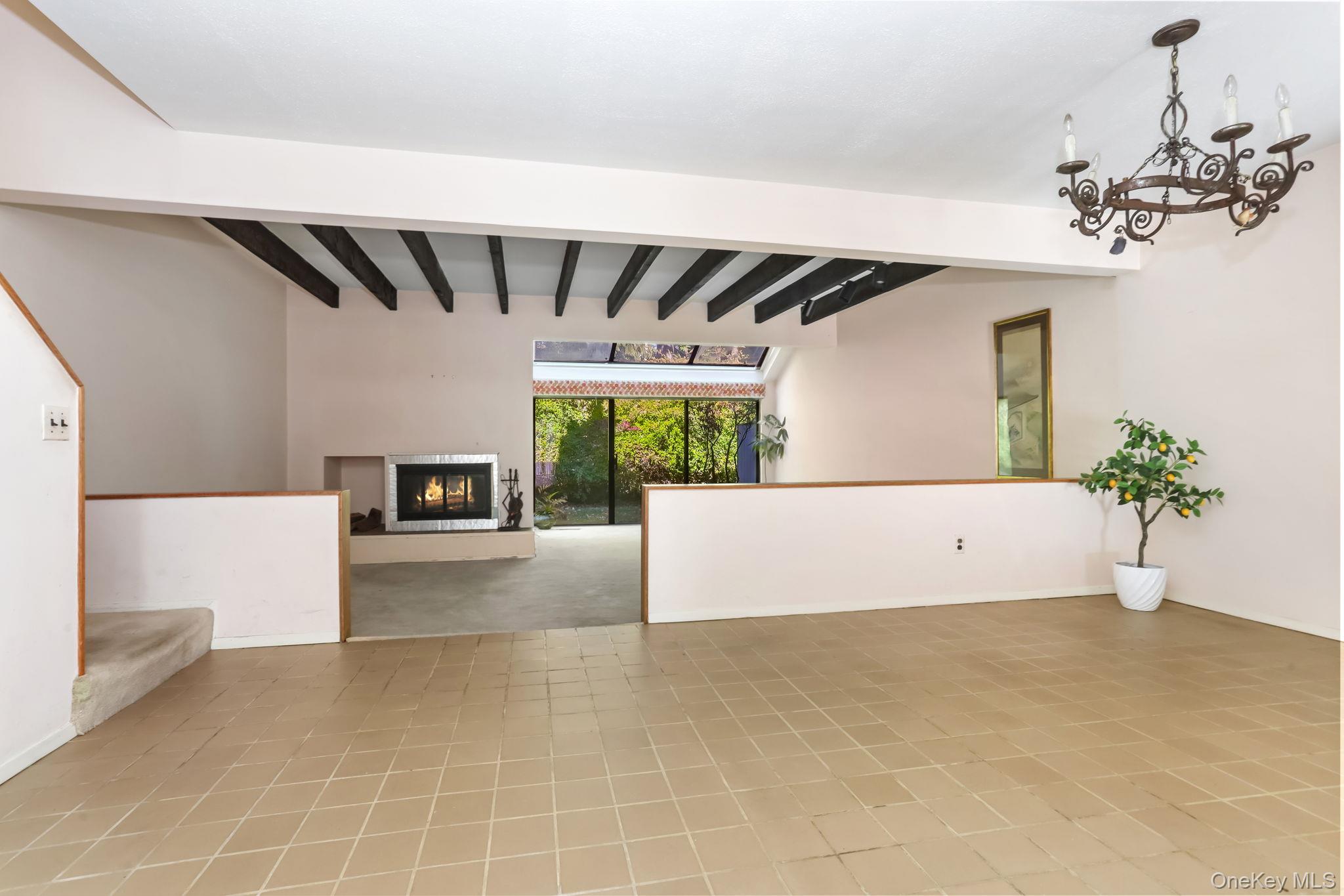 40 Pine Ridge Road Larchmont, NY 10538 - Photo 10 of 40 a view of a room with a chandelier and wooden floor