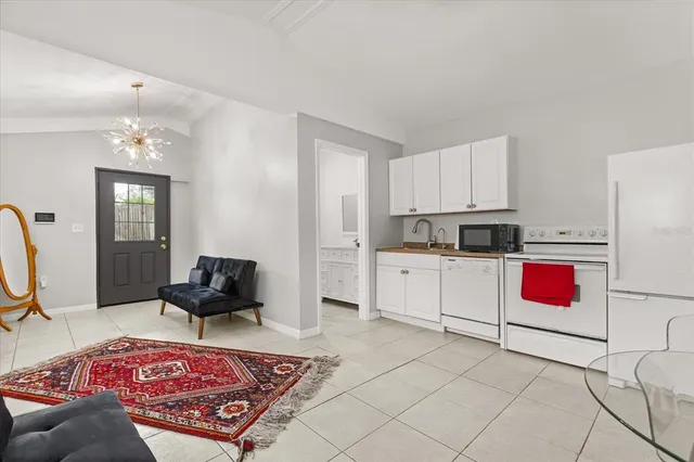 an aerial view of residential houses with outdoor space and ocean view