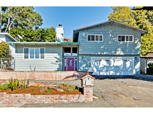 a view of a house with wooden fence
