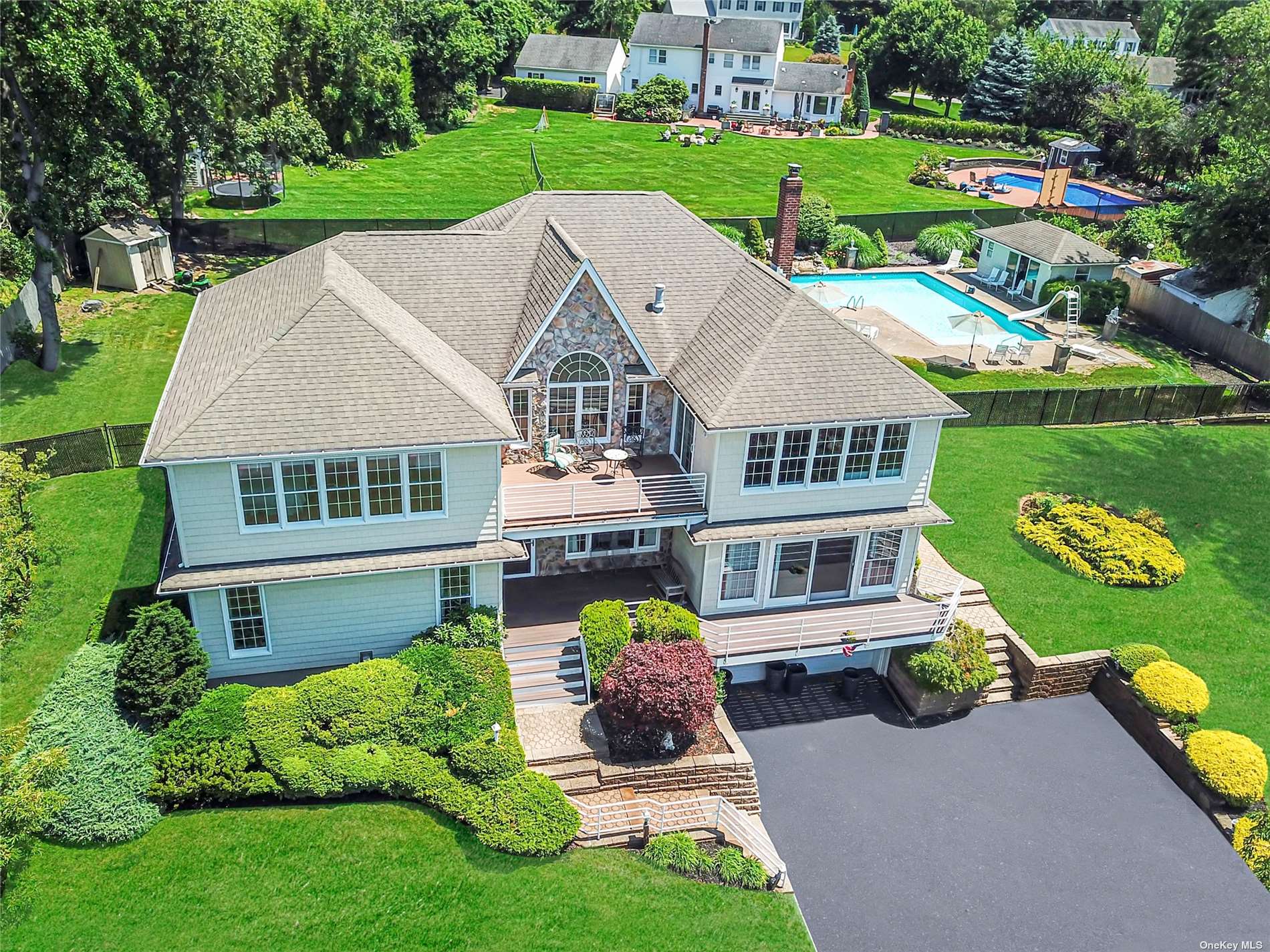 a aerial view of a house with swimming pool and a yard