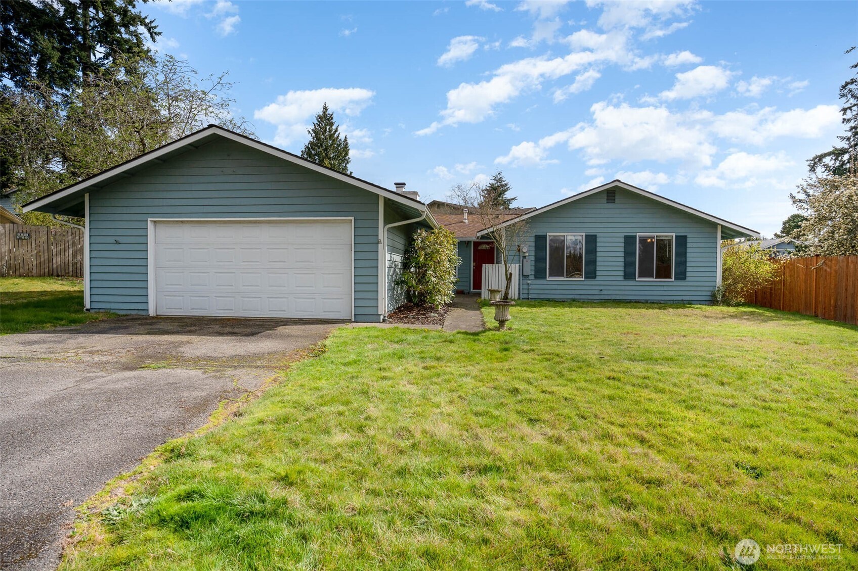 a view of a house with yard and a garden