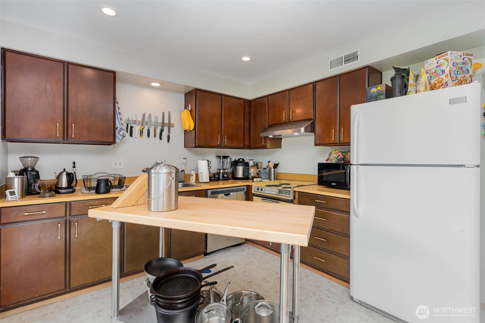 2107 Southeast 21st Court Renton, WA 98055 - Photo 20 of 28 a kitchen with a refrigerator a stove a sink and cabinets