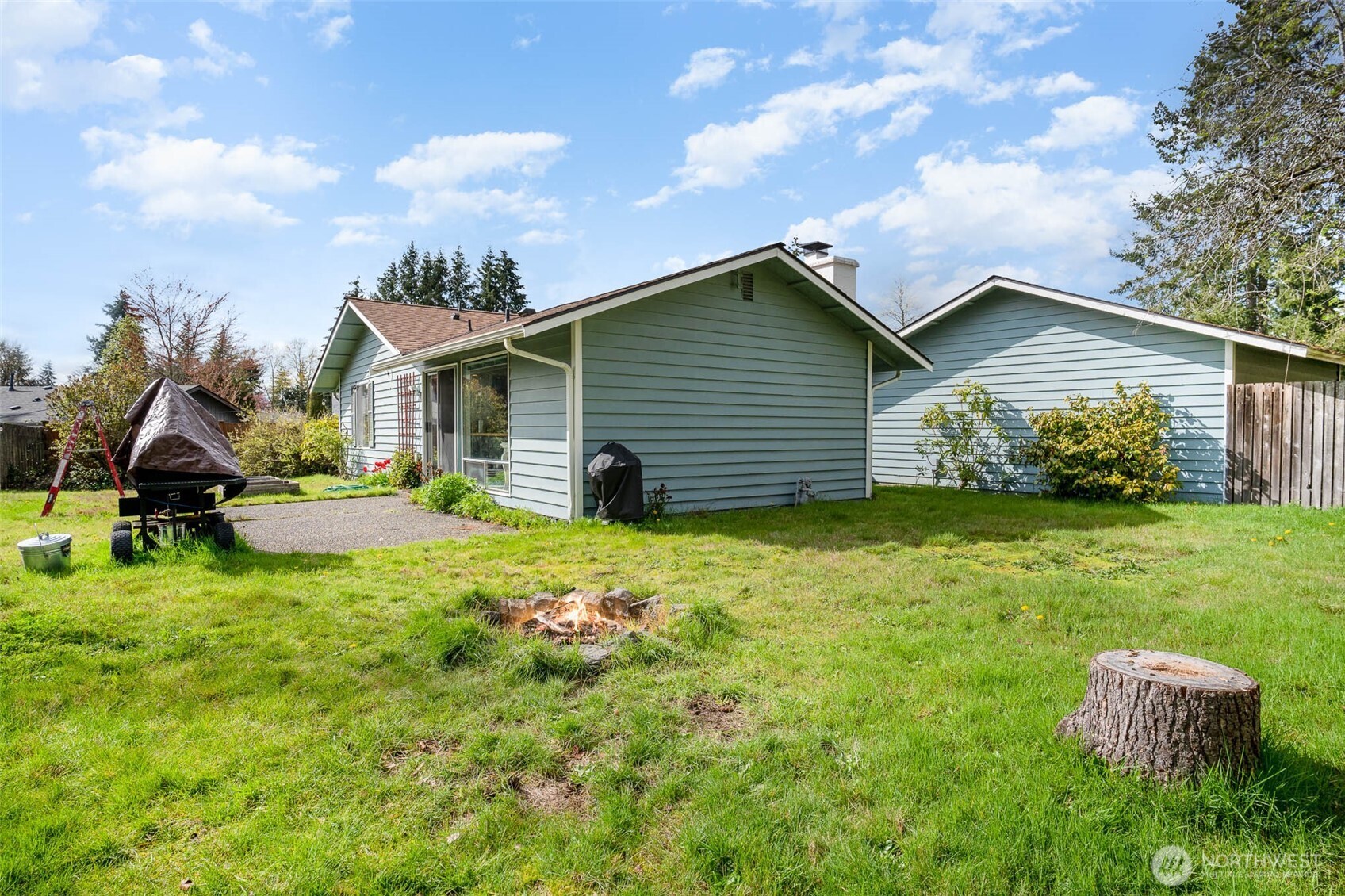 2107 Southeast 21st Court Renton, WA 98055 - Photo 26 of 28 a backyard of a house with table and chairs