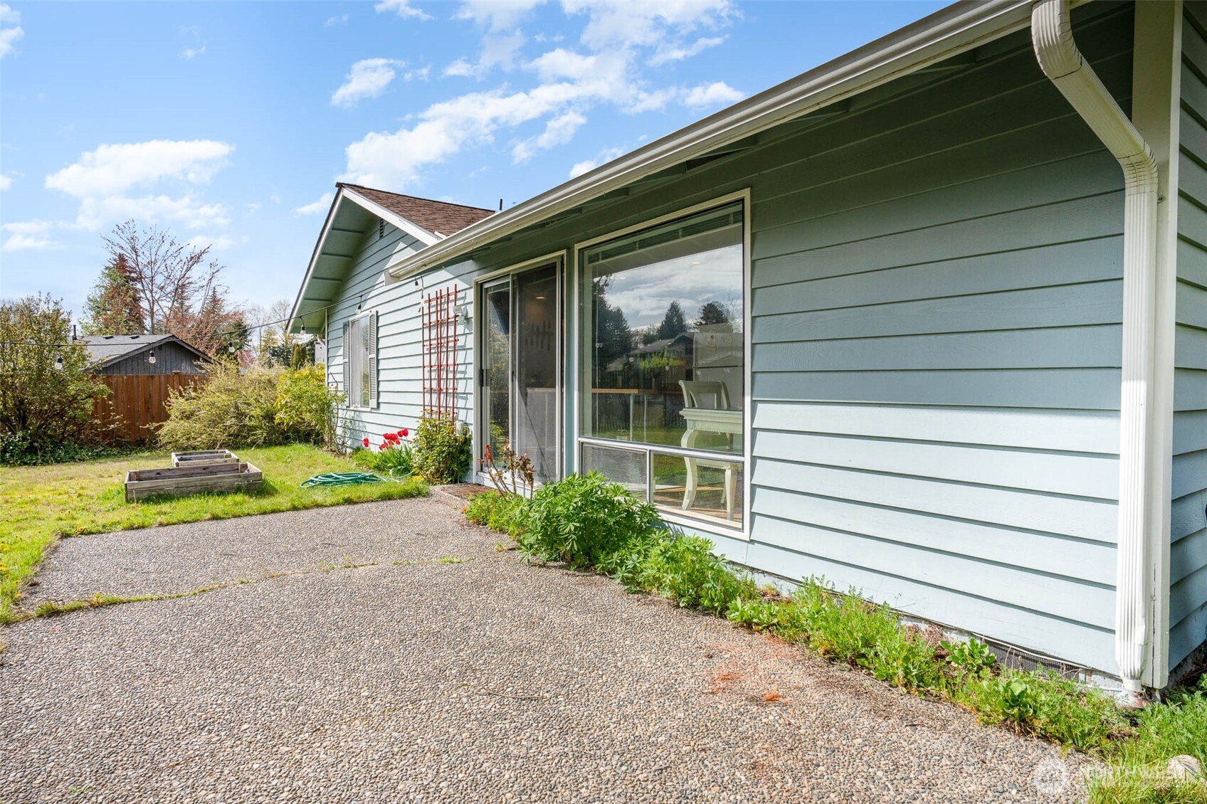 2107 Southeast 21st Court Renton, WA 98055 - Photo 27 of 28 a house with a yard and potted plants