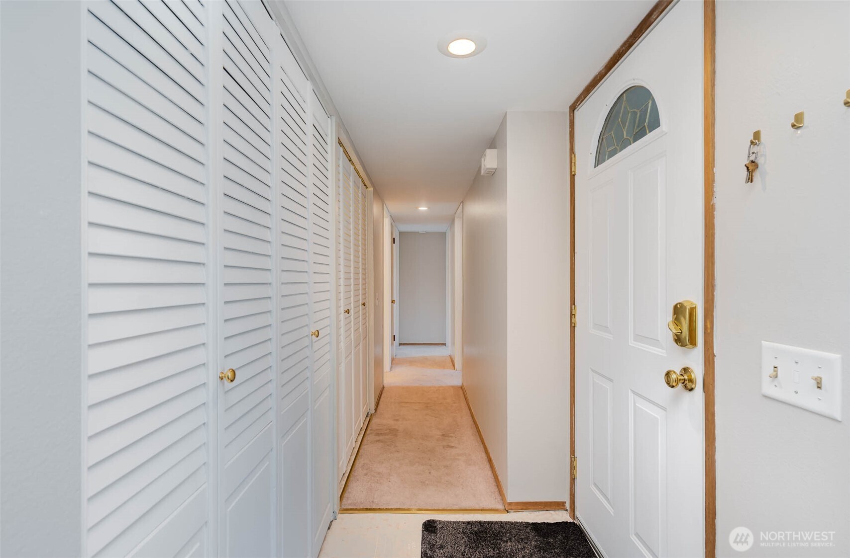 2107 Southeast 21st Court Renton, WA 98055 - Photo 5 of 28 a view of a hallway with closet and a white door