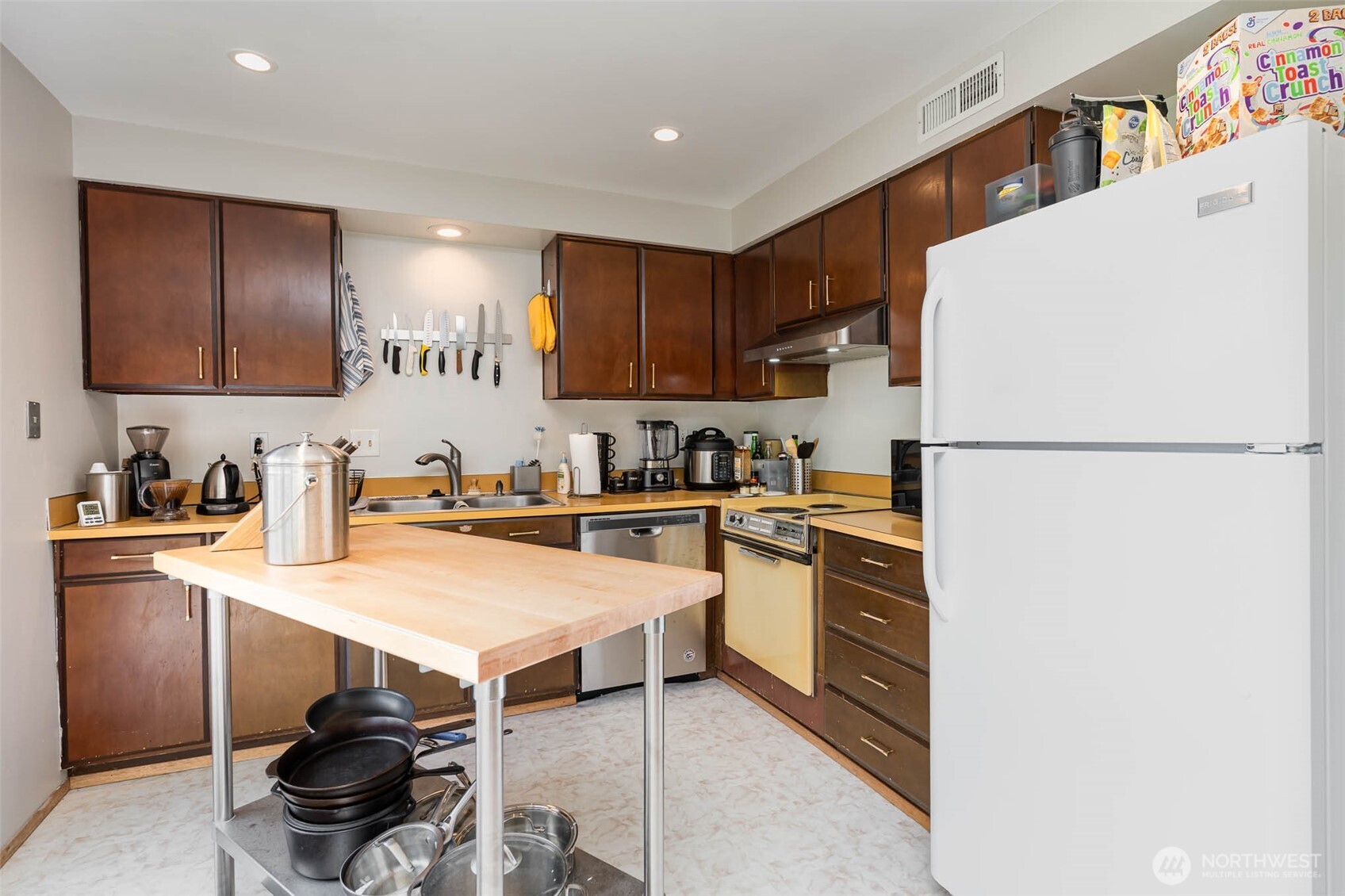 2107 Southeast 21st Court Renton, WA 98055 - Photo 6 of 28 a kitchen with a refrigerator and a stove top oven